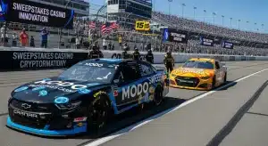 two-nascar-style-race-cars-sponsored-by-modo-and-chumba-racing-on-a-sunny-track